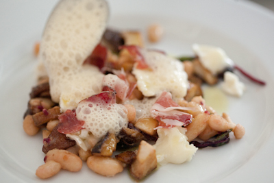 Mushrooms and white beans with sautéed beetroot leaves, crotin, coppa and topped with a sauce soubise